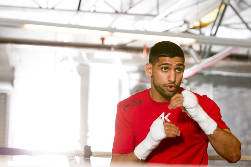Amir Khan shadow boxes during a workout session at Virgil Hunter’s Gym on April 24, 2014 in Hayward, California. Kahn is preparing to take on Luis Collazo at the MGM Grand in Las Vegas on May 3, 2014.   Alexis Cuarezma/Getty Images/AFP