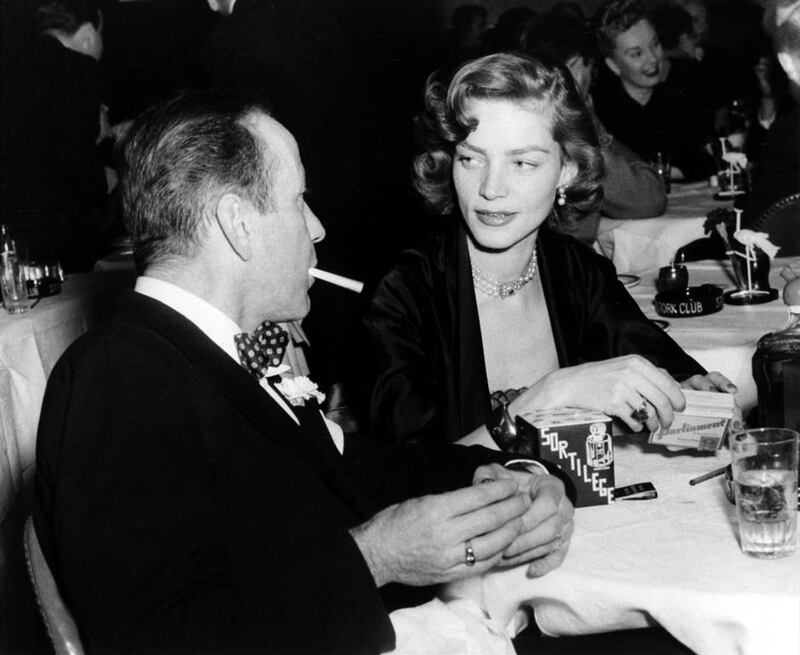 Humphrey Bogart, left, and his wife, actress Lauren Bacall, appear at the Stork Club in New York. AP