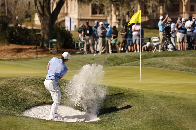 McIlroy hits out of a bunker on the ninth. EPA