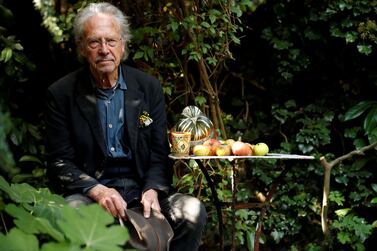 Peter Handke poses in his garden after winning the 2019 Nobel Prize in Literature, in Chaville, near Paris, France. Reuters