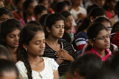 epa07804841 Indian students take part in the 'Largest Mindfulness Lesson' and 'Master Your Reality' session by Kamakshi P., a self hypnosis and energy coach during a Guinness World Record attempt in Bangalore, India, 30 August 2019. In total, 1748 students of took part in the 40-minute session consisting of motivation talks and meditation aimed to calm and relax  students from anxiety and stress to manage psychological challenges.  EPA/JAGADEESH NV