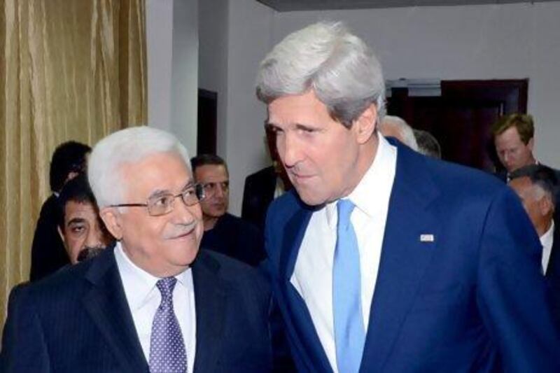 A photograph released by the Palestinian Authority shows John Kerry and Mahmoud Abbas heading to a meeting in Ramallah on Friday. Thaer Ganaim / EPA