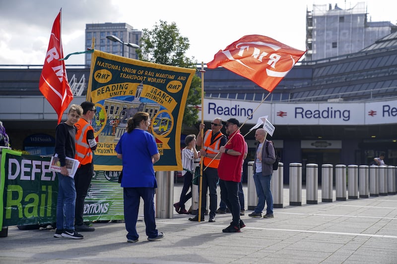 Members of the Rail, Maritime and Transport union on the picket line outside Reading station. PA