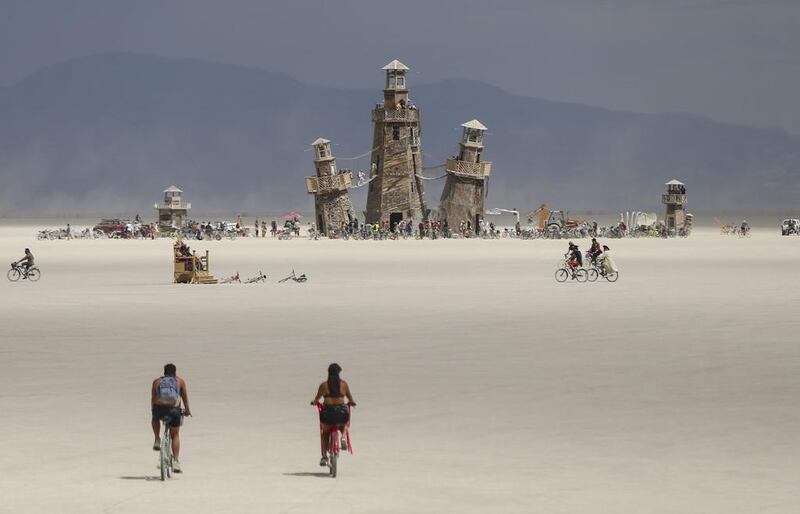 The Black Rock Lighthouse Service installation is shown in the distance during Burning Man at the Black Rock Desert near Gerlach, Nevada. Chase Stevens / Las Vegas Review-Journal via AP