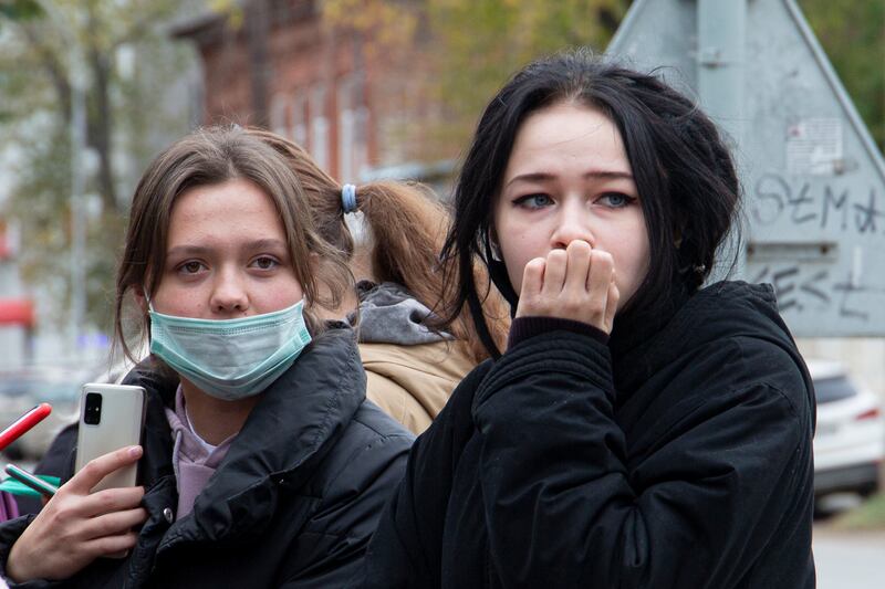 Students react near Perm State University, where eight people have been killed in a shooting. AP