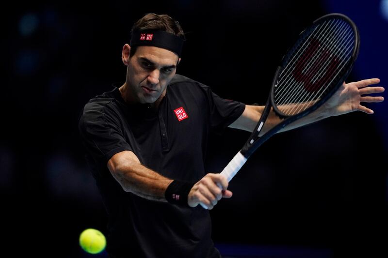 epa07997167 Roger Federer of Switzerland returns to Novak Djokovic of Serbia during his round robin match against at the ATP World Tour Finals tennis tournament in London, Britain, 14 November 2019.  EPA/WILL OLIVER