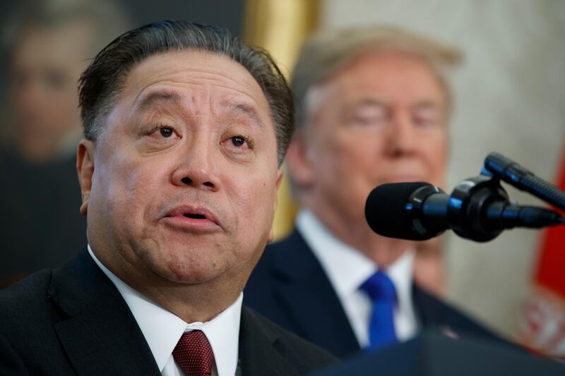 FILE - In this Thursday, Nov. 2, 2017, file photo, Broadcom CEO Hock Tan speaks as President Donald Trump listens during an event to announce the company is moving its global headquarters to the United States, in the Oval Office of the White House, in Washington. Broadcom is making an unsolicited, $130 billion offer for rival chipmaker Qualcomm. (AP Photo/Evan Vucci, File)