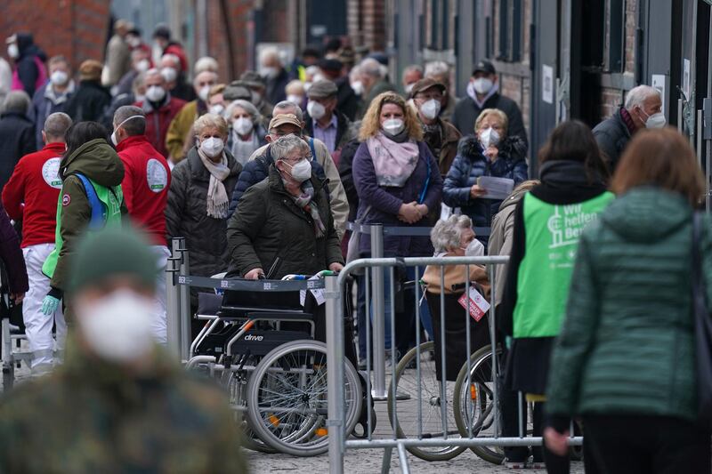People, most of them elderly, wait in line to enter the Arena vaccination center in Berlin, Germany. Getty Images