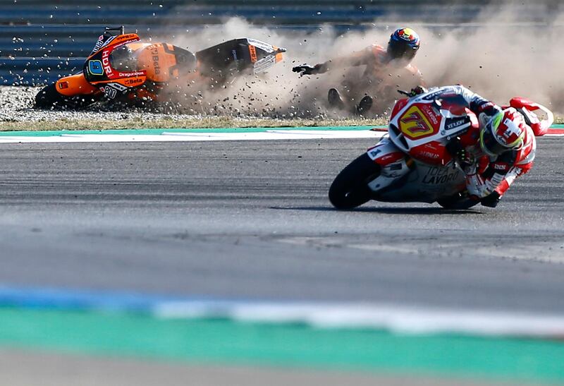 Spain's rider Jorge Navarro of the Beta Tools Speed Up crashes behind Switzerland's rider Dominique Aegerter of the MV Agusta Idealavoro Forward steers his motorcycle during a warm up session for the Moto2 race of the Dutch Grand Prix in Assen, northern Netherlands.  AP