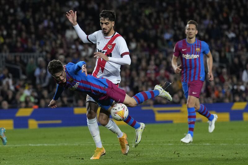 Barcelona midfielder Gavi goes down under a challenge from Rayo's Alejandro Catena. EPA 