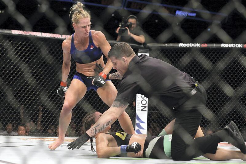 SINGAPORE - JUNE 17:  The referee stops the fight between Holly Holm of United States (L) and Bethe Correia of Brazil  in the WomenÃ•s Bantamweight Main Event Bout during UFC Singapore Fight Night at Singapore Indoor Stadium on June 17, 2017 in Singapore.  (Photo by Suhaimi Abdullah/Getty Images)