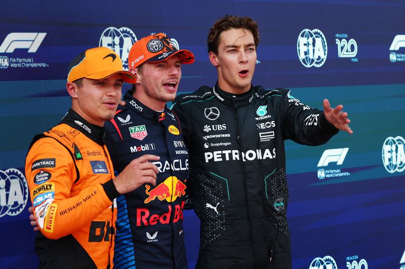 Max Verstappen celebrates after qualifying in pole position with second-placed Lando Norris of McLaren and third-placed George Russell of Mercedes. Reuters