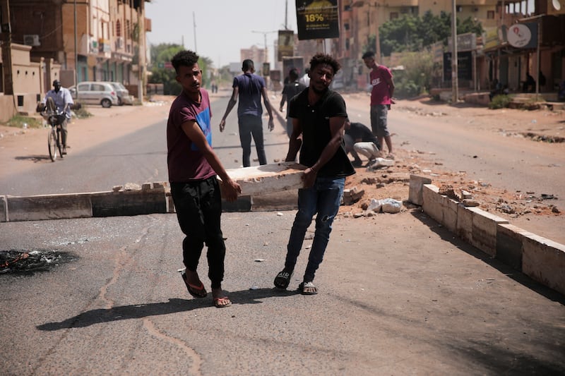 Demonstrators set up a barricade during a protest.  AP