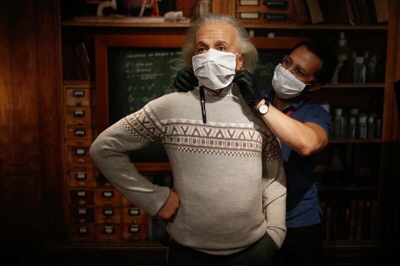 In order to raise awareness against the spread of the coronavirus, a worker at Madame Tussauds museum in Istanbul, places a mask on the wax figure of Albert Einstein during a photo-op. AP Photo