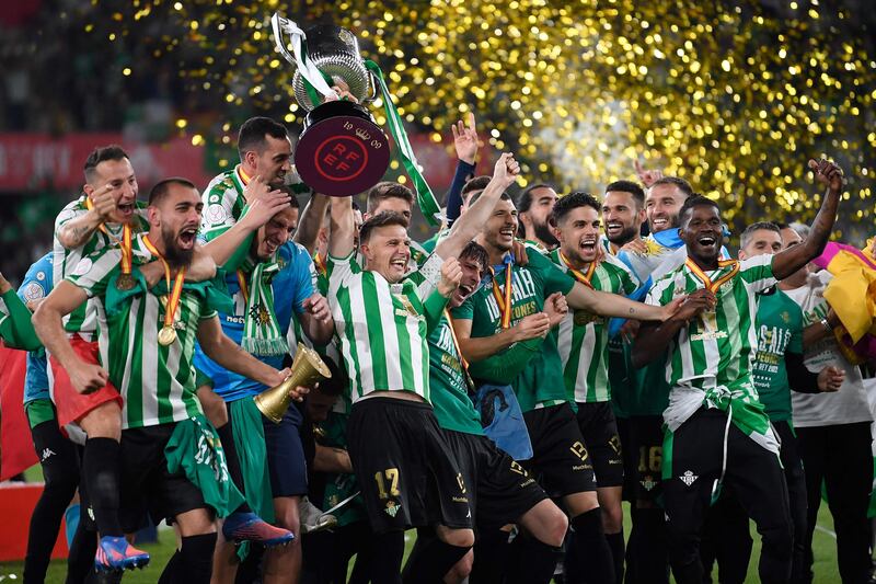 Real Betis captain Joaquin raises the Copa del Rey as he celebrates with teammates after winning the final on penalties against Valencia at La Cartuja Stadium on April 23, 2022. AFP