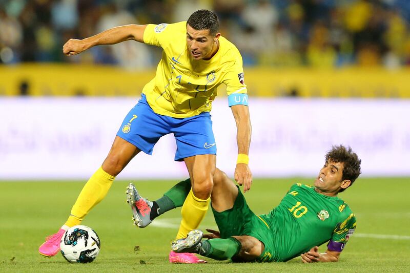 Al Nassr's Cristiano Ronaldo wins the ball off Al Shorta's Alaa Al Azzawi. AFP