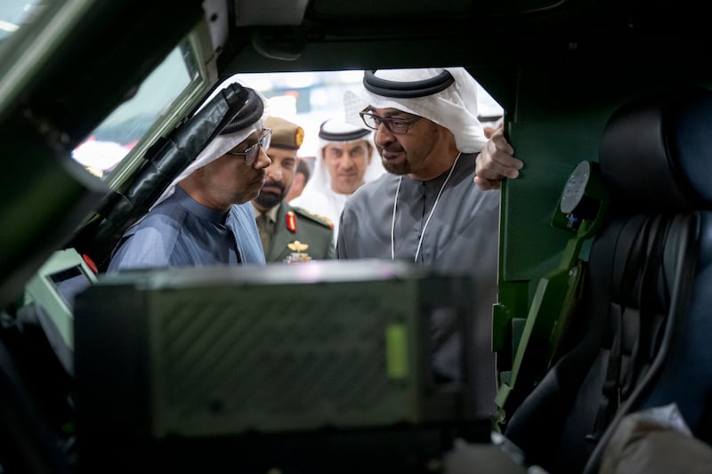 The President and Sheikh Mansour view the interior of a vehicle during a tour of the exhibition