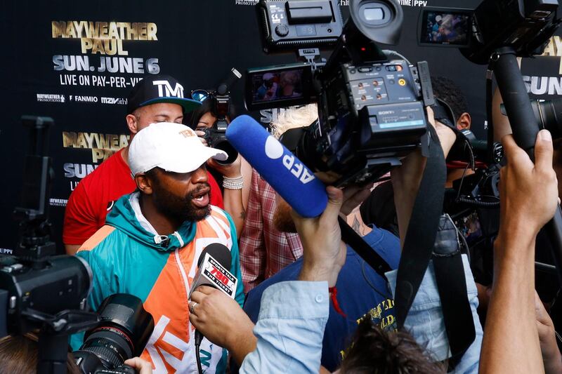 Floyd Mayweather reacts before Jake Paul took his hat during a media day for Mayweather's fight against Logan Paul at Hard Rock Stadium. AFP