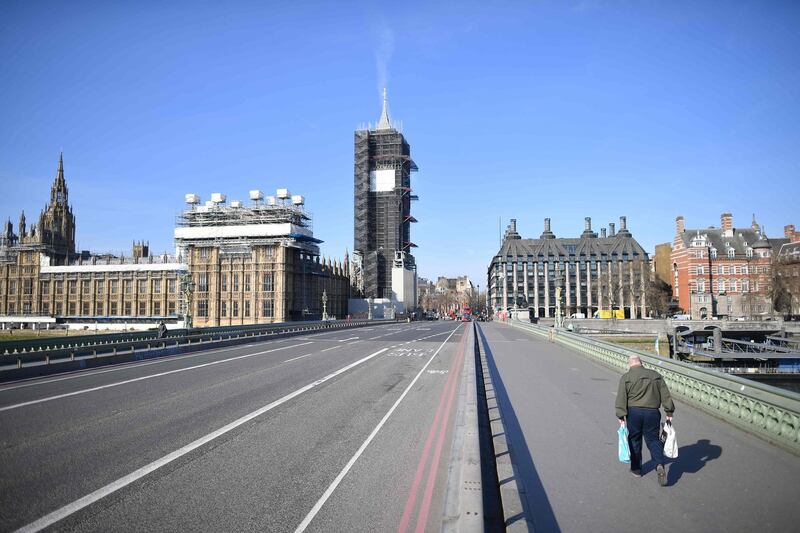 A picture shows the Houses of Parliament at the end of an empty Westminster Bridge in central London,  the morning after Britain ordered a lockdown to slow the spread of the novel coronavirus.  AFP