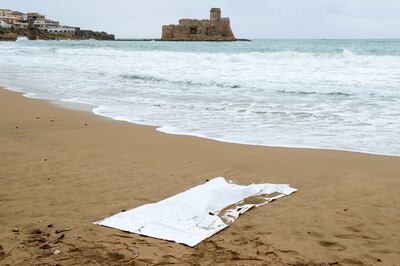 A covered body is seen on the beach in the aftermath of a deadly migrant shipwreck, in Le Castella, Italy. Reuters 