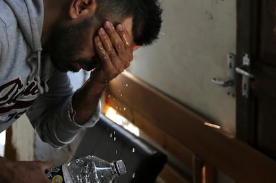 In this Tuesday, Nov. 20, 2018, Hawye Rasool Saleh, 32, a migrant from Iraq washes his face at his living space under a hotel in central Nicosia, Cyprus.  Cyprus was not seen as an attractive destination for migrants seeking shelter and a new life in Europe, but that has changed as other nations in Europe have shut their borders and the economic situation has slowly improved for this small island nation.(AP Photo/Petros Karadjias)