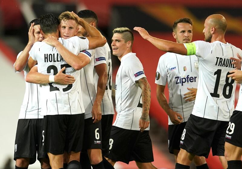 LASK's Philipp Wiesinger, third left, is congratulated by teammates after scoring his team's goal at Old Trafford. AP