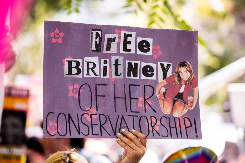 A demonstrator holds a poster reading 'Free Britney of her Conservatorship' during a #FreeBritney protest in front of the court house where a hearing is scheduled in the Britney Spears' conservatorship case in Los Angeles, California.