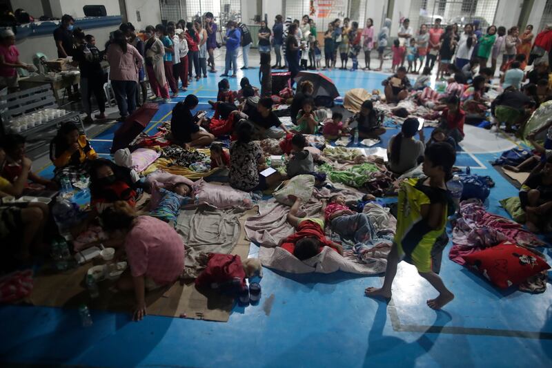 Evacuees rest inside a gym turned into a temporary evacuation centre in Manila. EPA