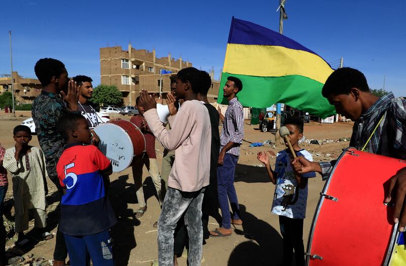Sudanese youths beat drums and chant slogans as they tour neighbourhoods in the capital Khartoum in support of the families of protesters killed since last year's military coup. AFP