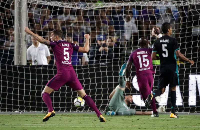 Manchester City's John Stones celebrates a goal by Nicolas Otamendi. Jae C Hong / AP Photo