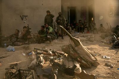 U.S.-backed Syrian Democratic Forces (SDF) fighters rest after returning from the front line after territorial gains over Islamic State militants in Baghouz, Syria, Tuesday, March 19, 2019.  On Tuesday, a spokesman for U.S.-backed forces fighting IS in Syria says his fighters are in control of an encampment in the village of Baghouz where IS militants have been besieged for months. (AP Photo/Maya Alleruzzo)