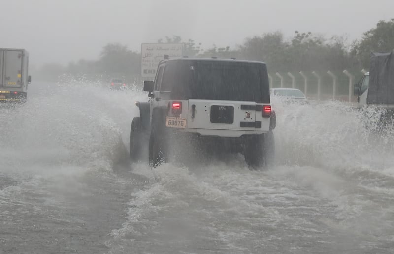 Vehicles splash through the Dubai – Abu Dhabi motorway during the heavy rain in Abu Dhabi. Pawan Singh / The National