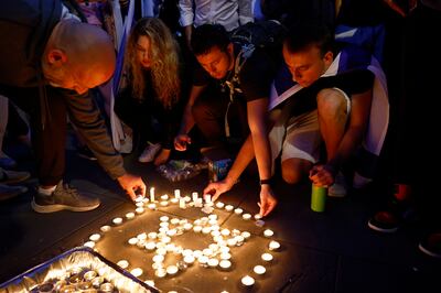 Members of the Jewish community light candles during a vigil for Israel at Downing Street, London, on October 9. Getty Images