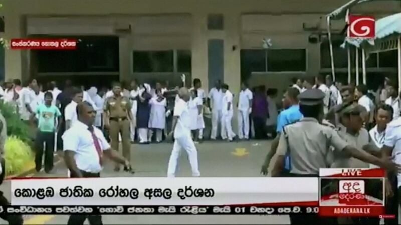 A crowd waits at a hospital. Derana TV/via Reuters