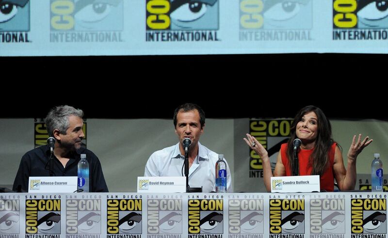SAN DIEGO, CA - JULY 20: (L-R) Director Alfonso Cuaron, producer David Heyman and actress Sandra Bullock speak onstage at the Warner Bros. and Legendary Pictures preview of "Gravity" during Comic-Con International 2013 at San Diego Convention Center on July 20, 2013 in San Diego, California.   Kevin Winter/Getty Images/AFP== FOR NEWSPAPERS, INTERNET, TELCOS & TELEVISION USE ONLY ==
 *** Local Caption ***  586057-01-09.jpg