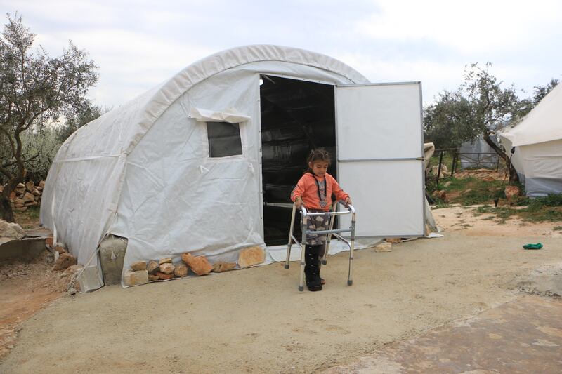 Jinan uses a walker outside her tent. Abd Almajed Alkarh / The National