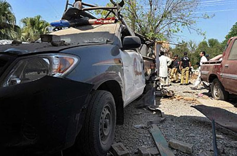 Policemen inspect a damaged police station after a suicide blast in the town of Kohat, north-west Pakistan.