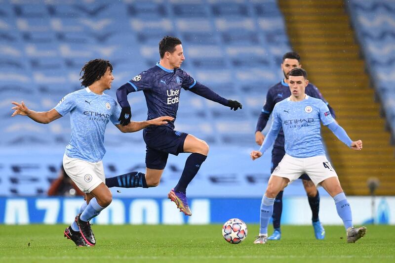 Manchester City's Dutch defender Nathan Ake (L) vies with Marseille's French forward Florian Thauvin during the UEFA Champions League 1st round day 6 group C football match between Manchester City and Marseille at the Etihad Stadium in Manchester, north west England, on December 9, 2020. (Photo by Paul ELLIS / AFP)