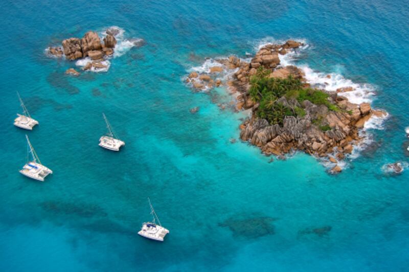 Handout aerial view of a paradise island with a few boats around in Seychelles. Courtesy of Emirates Airlines