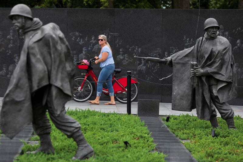 A visitor wheels a bicycle through the newly renovated Korean War Veterans Memorial on the National Mall in Washington. Reuters