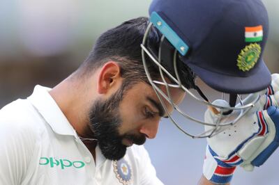 India's Virat Kohli removes his helmet as he walks off after being dismissed during play in the second cricket test between Australia and India in Perth, Australia, Monday, Dec. 17, 2018. (AP Photo/Trevor Collens)