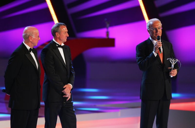 Franz Beckenbauer, right, accepts the Laureus Lifetime Achievement Award from fellow greats Sir Bobby Charlton, left, and Johan Cruyff. Getty Images
