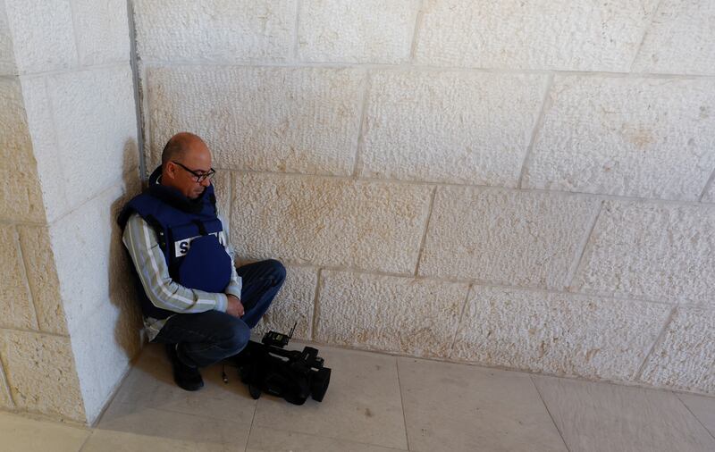 A cameraman grieves at a hospital. Reuters