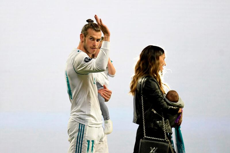 Real Madrid's Welsh forward Gareth Bale waves at the Santiago Bernabeu stadium in Madrid on May 27, 2018 during a victory ceremony after Real Madrid won its third Champions League title in a row in Kiev.  / AFP / OSCAR DEL POZO
