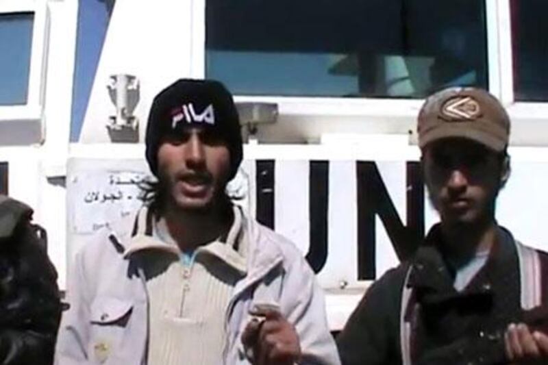 An image from a video uploaded on YouTube on Wednesday allegedly shows Syrian rebels standing in front of a UN vehicle in the Golan Heights. AFP