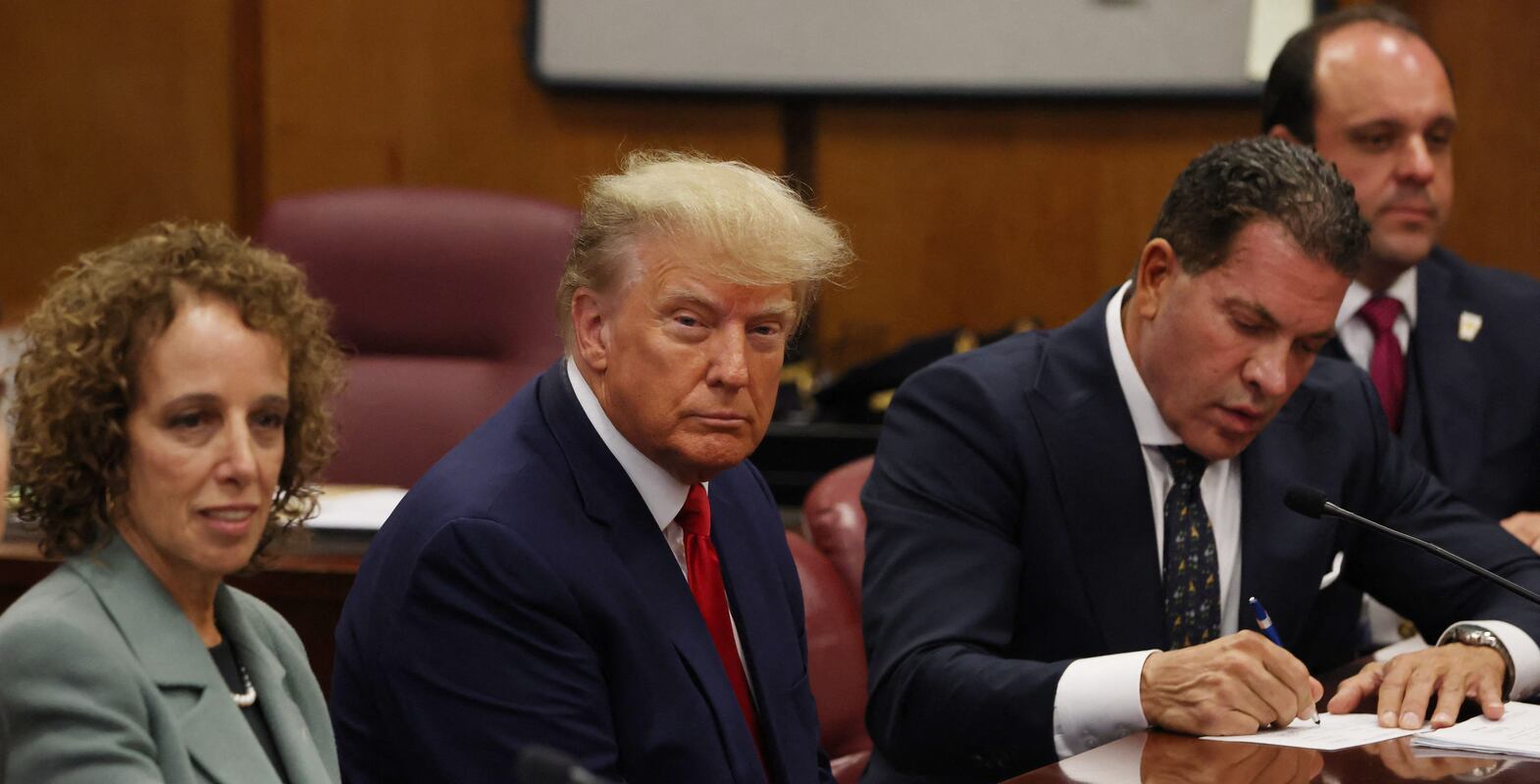 Former US president Donald Trump is accompanied by members of his legal team as he appears in court for an arraignment. Reuters