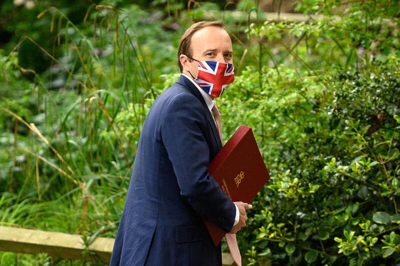 LONDON, ENGLAND - MAY 27: Health Secretary Matt Hancock wearing a Union Jack face mask walks towards the media briefing room in Downing Street on May 27, 2021 in London, England. (Photo by Leon Neal/Getty Images)