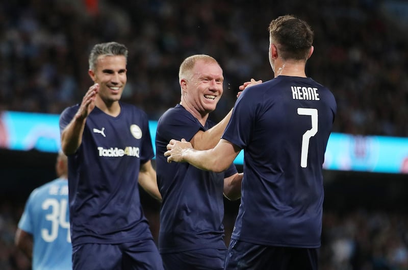 Premier League All-Stars' Robbie Keane celebrates scoring their first goal with Paul Scholes. Reuters