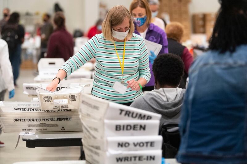 An election worker sorts through ballots during a Cobb County hand recount of Presidential votes on Sunday, Nov. 15, 2020, in Marietta, Ga. (John Amis/Atlanta Journal & Constitution via AP)