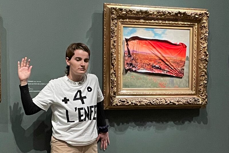 An environmental activist was detained after sticking a protest sign on a Monet painting, calling for action to protect food supplies from further damage to the climate. AP